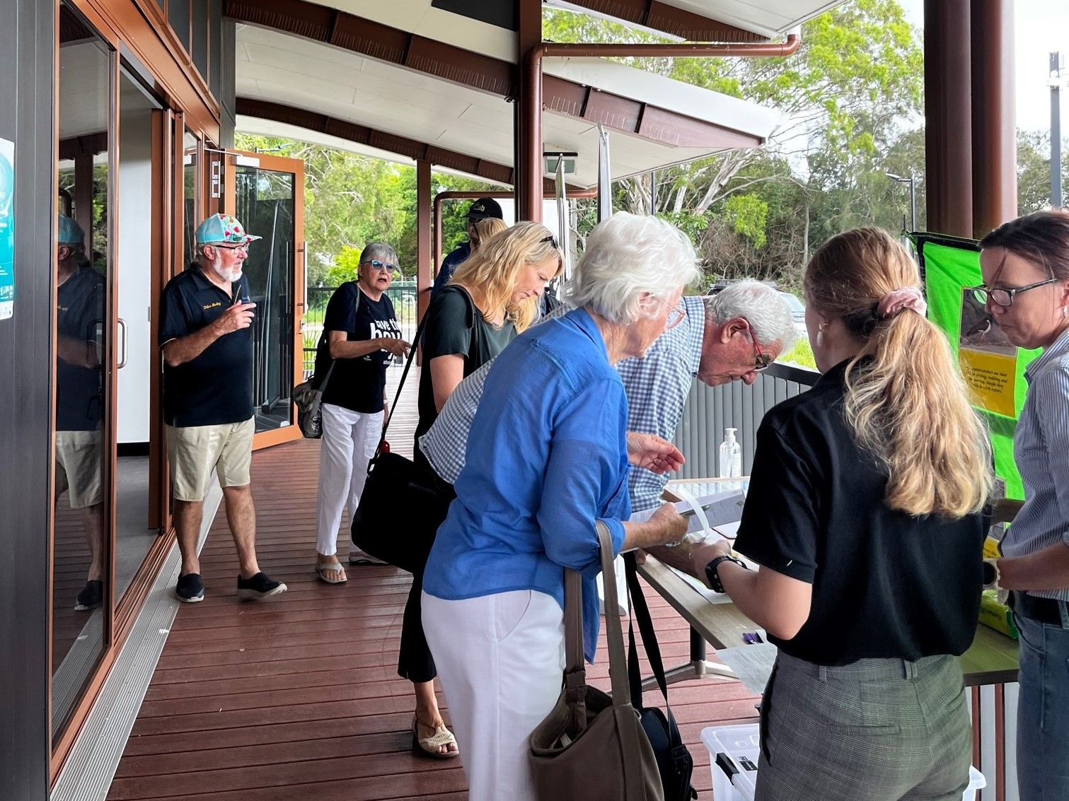 Moreton Bay stakeholders outside on location deck registering for the event